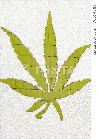 The green cannabis leaf is lined with paving stones. Medical marijuana cultivation concept. The green cannabis leaf is lined with paving stones. Medical marijuana cultivation concept. 70954380