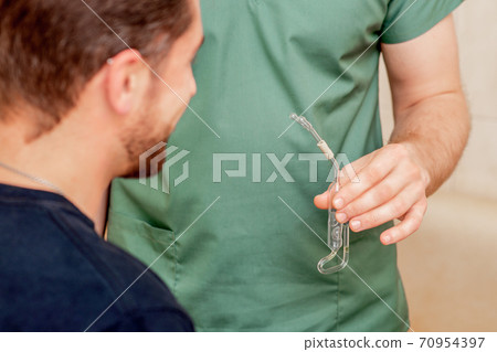 Doctor holds nasal inhalator. 70954397