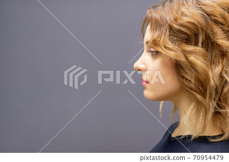 Woman with red long wavy hairstyle 70954479