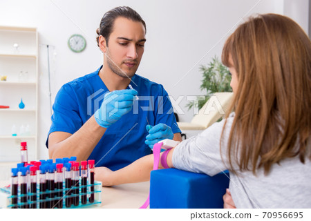 Young woman in blood transfusion concept 70956695
