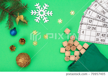 Wooden lotto barrels with bag and Christmas fir tree branches, cones, toy balls Wooden lotto barrels with bag and Christmas fir tree branches, cones, toy balls 70957405