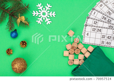 Wooden lotto barrels with bag and Christmas fir tree branches, cones, toy balls Wooden lotto barrels with bag and Christmas fir tree branches, cones, toy balls 70957514