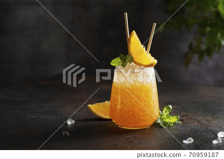 Fresh cold cocktial with orange, crushed ice and mint 70959187