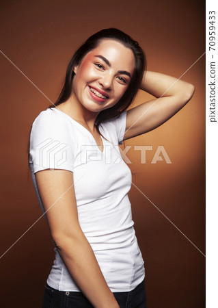 pretty girl happy posing: brunette on brown background, lifestyle people concept pretty girl happy posing: brunette on brown background, lifestyle people concept 70959433