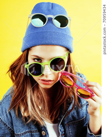 lifestyle people concept: pretty young school teenage girl having fun happy smiling on yellow background lifestyle people concept: pretty young school teenage girl having fun happy smiling on yellow background 70959434