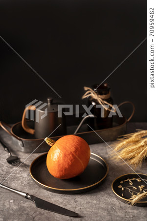 Vintage template with old metal tableware, ripe pumpkin and ear of wheat on black stone background for concept design. Fall concept. 70959482