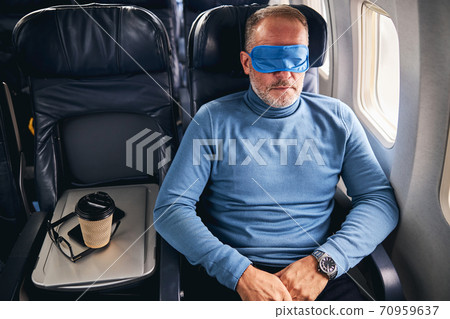 Male passenger dozing off on the plane Male passenger dozing off on the plane 70959637