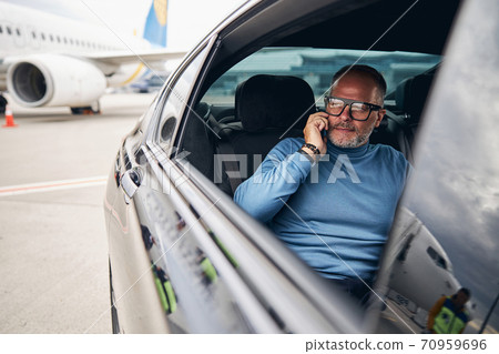 Passenger in a taxi parked at the airdrome 70959696