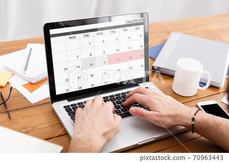 Man Working With Calender Planner On Laptop In Office, Managing Business Schedule 70963443