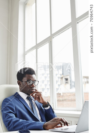 African businessman using laptop 70964743