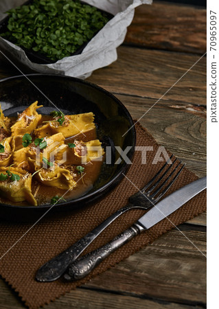 Italian ravioli stuffed with meat closeup on a black plate. rustic style 70965097