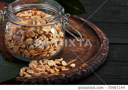 Deep fried peanuts on dark table background Deep fried peanuts on dark table background 70965144
