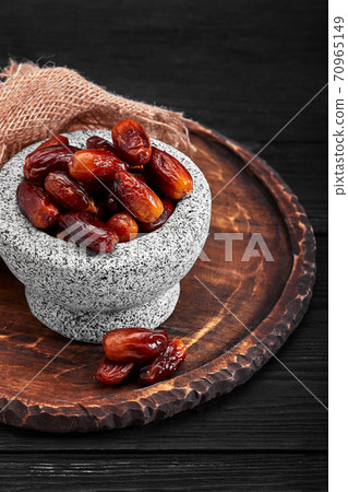 Bowl of dried dates on dark wooden background 70965149