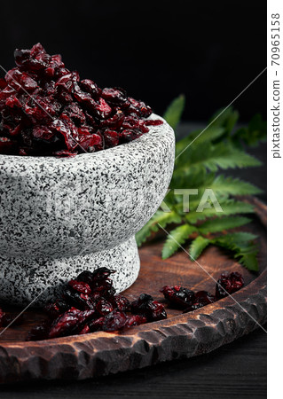 Dried cherry in a bowl over gray background. Top view. Dried cherry in a bowl over gray background. Top view. 70965158