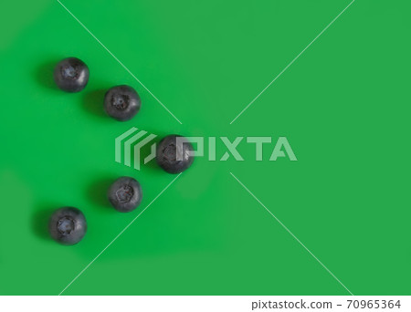 Blueberries on a green background Blueberries on a green background 70965364