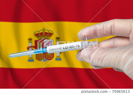 Coronavirus COVID-19 vaccination concept in Spain with doctor hand and syringe Coronavirus COVID-19 vaccination concept in Spain with doctor hand and syringe 70965613