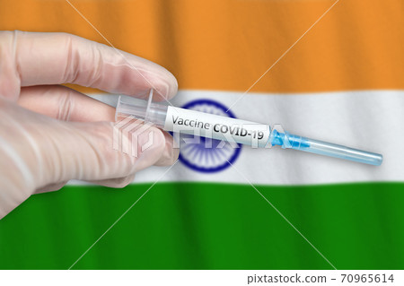 Coronavirus COVID-19 vaccination concept in India with doctor hand and syringe 70965614