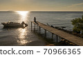Woman Enjoying Sunset on Pier 70966365