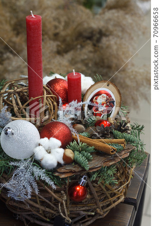 Christmas or New Year composition. Wicker basket with fir branches decorated by natural materials on grey background Christmas or New Year composition. Wicker basket with fir branches decorated by natural materials on grey background 70966658