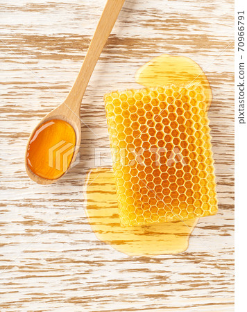 honeycombs from a bee hive filled with organic honey on white table, top view. honeycombs from a bee hive filled with organic honey on white table, top view. 70966791