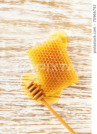 honeycombs from a bee hive filled with organic honey on white table, with copy space. honeycombs from a bee hive filled with organic honey on white table, with copy space. 70966792
