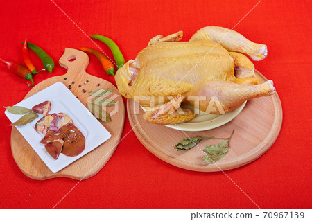 Raw chicken on red background 70967139
