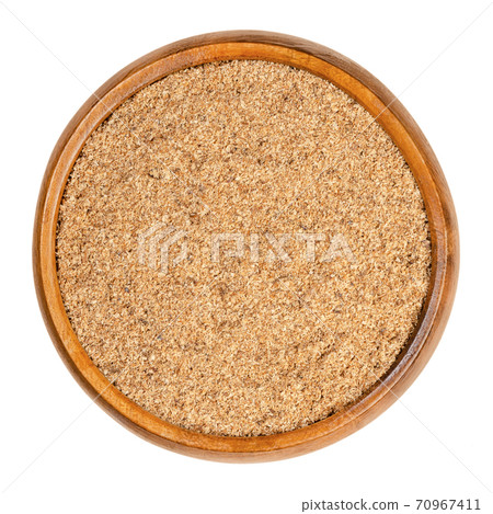 Freshly grated nutmeg in a wooden bowl. Also known as fragrant or true nutmeg, the seeds of the tree Myristica fragrans, used as spice and in traditional medicine. Close-up, from above, food photo. 70967411