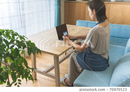 A woman using a card A woman using a card 70970523