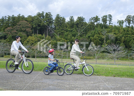 Family biking in the park Family biking in the park 70971987