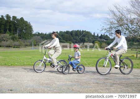 Family biking in the park Family biking in the park 70971997
