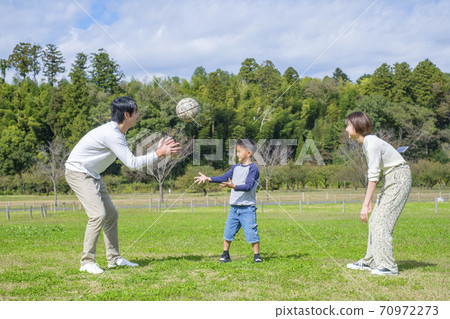 Family playing ball in the park 70972273