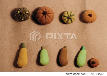 Cute miniature handmade pumpkins flat lay on crafted brown paper. Cute miniature handmade pumpkins flat lay on crafted brown paper. 70973568
