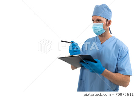 Male surgeon writing on clipboard against white background Male surgeon writing on clipboard against white background 70975611