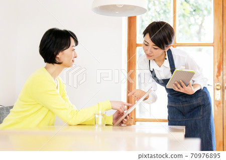 Cafe clerk receiving an order Cafe clerk receiving an order 70976895
