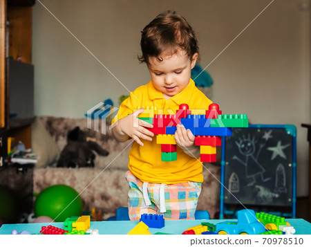 Cute little boy child playing at home with colorful cubes Cute little boy child playing at home with colorful cubes 70978510