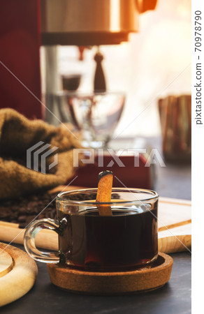 Cup of coffee with cinnamon stick. Cup of coffee with cinnamon stick. 70978790
