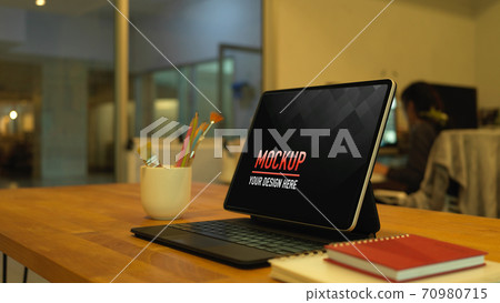 Worktable with digital tablet, paint brushes and notebooks, clipping path 70980715