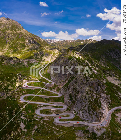 Aerial view of an old road going through the St. Gotthard pass in the Swiss Alps Aerial view of an old road going through the St. Gotthard pass in the Swiss Alps 70981478