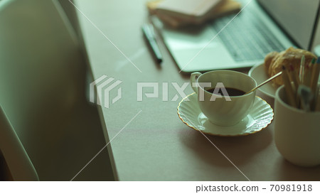 Side view of breakfast meal with coffee cup and croissant on workspace Side view of breakfast meal with coffee cup and croissant on workspace 70981918