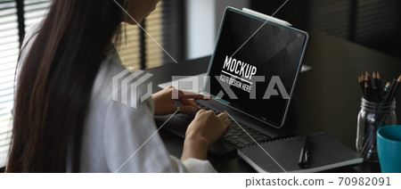 Businesswoman working with mock up tablet in office room, include clipping path Businesswoman working with mock up tablet in office room, include clipping path 70982091