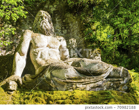 Colossal sculpture of god Neptune at famous Park of the Monsters, also named Sacred Grove, Bomarzo Gardens, province of Viterbo, Lazio, Italy 70982188