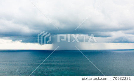 Rain pillars falling on the sea 70982221