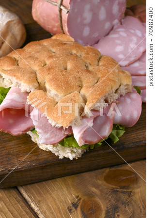 Traditional Italian antipasti mortadella on a wooden plate 70982400