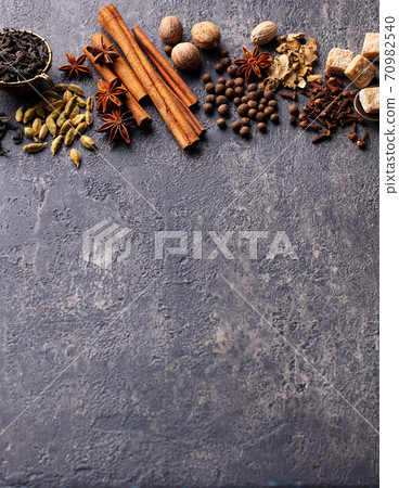 Spices for Indian masala tea. Grey background. Copy space. 70982540