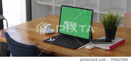 Wooden table with tablet, smartphone, accessories and book, include clipping path Wooden table with tablet, smartphone, accessories and book, include clipping path 70982996