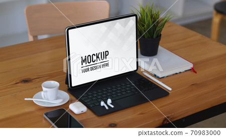 Wooden table with tablet, smartphone, accessories and book, include clipping path 70983000