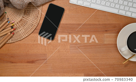 Wooden table with smartphone, coffee cup, keyboard, pencils and copy space Wooden table with smartphone, coffee cup, keyboard, pencils and copy space 70983340