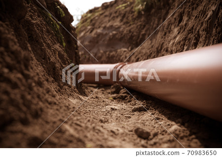 plastic pipes in the ground for wastewater and rainwater 70983650