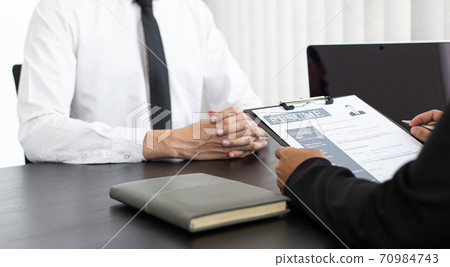 HR head is reading the resume and information about the candidate's history, Field employers are interviewing job applicants and negotiating agreements, Recruitment and job applications concept. 70984743