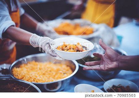 The hands of the poor have been begging to donate food from the donor, The concept of feeding The hands of the poor have been begging to donate food from the donor, The concept of feeding 70985503